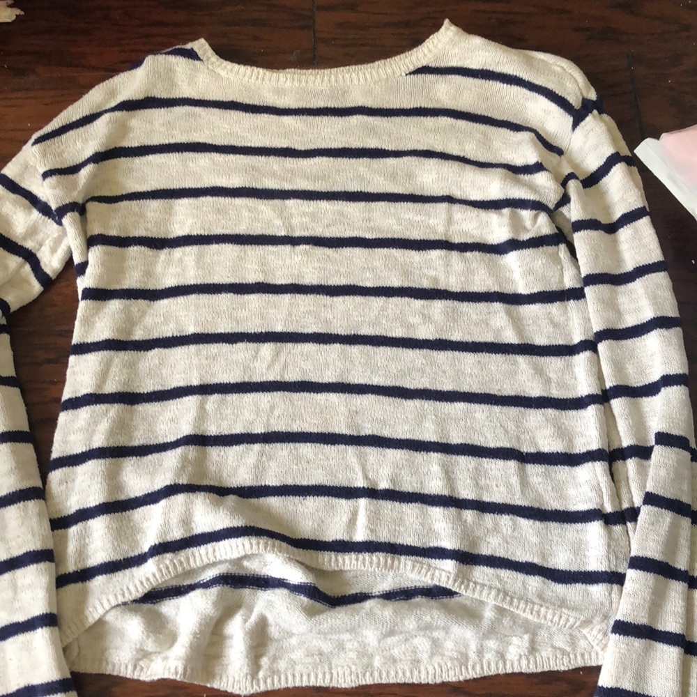 i’m selling this white sweater with blue stripes. it’s a medium in women’s.